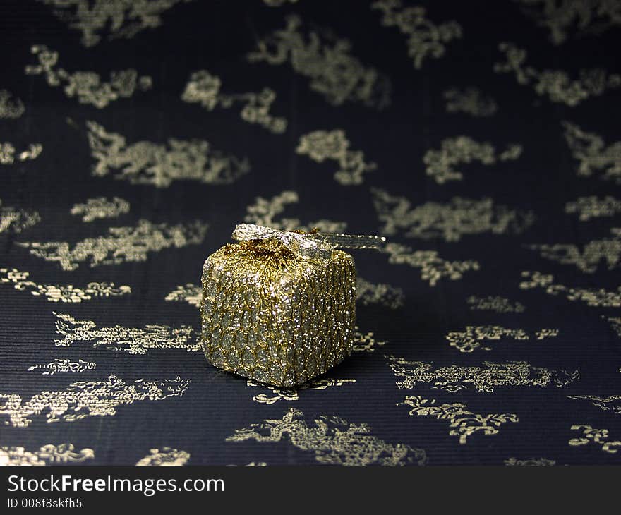 Close up of a silver christmas box on decorated background