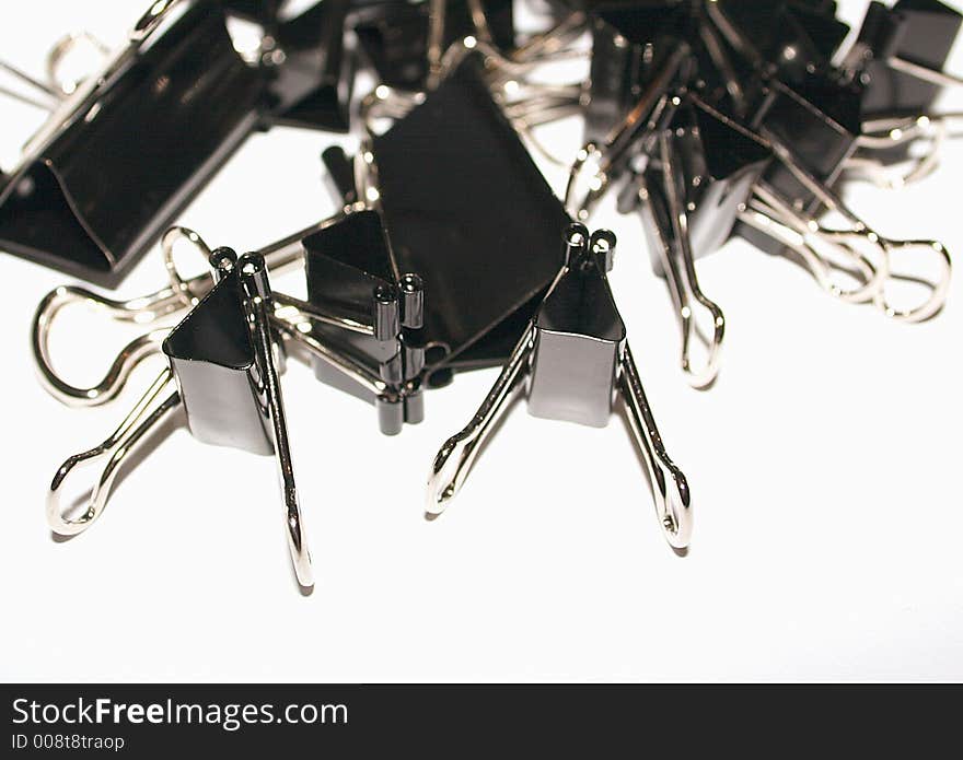 Assorted black bull clips in a pile. Assorted black bull clips in a pile