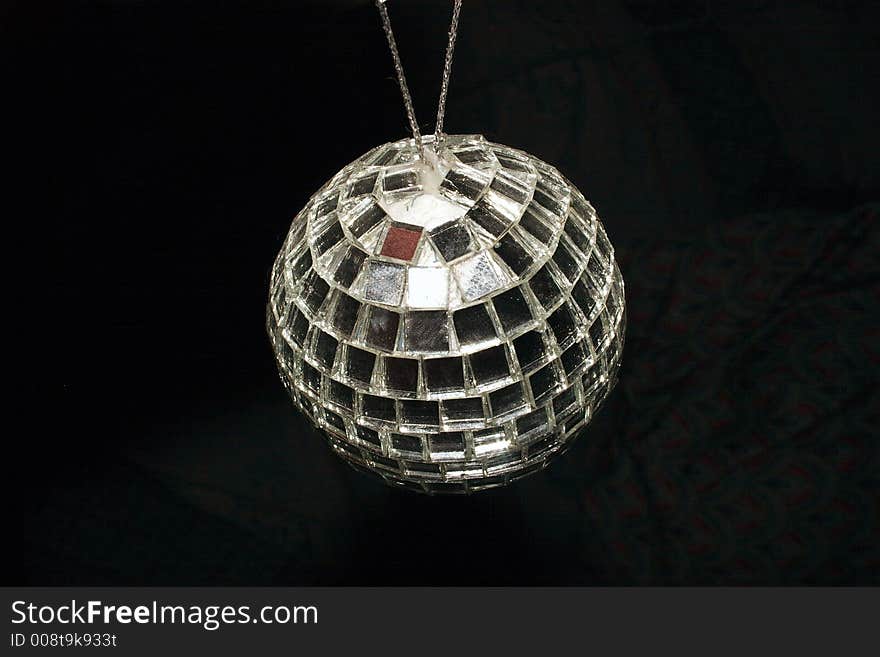 Mirrored disco ball over black