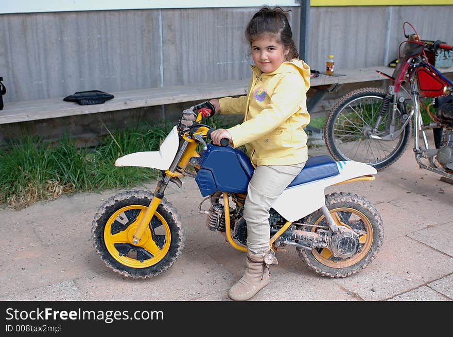 A little girl on a motorcycle. A little girl on a motorcycle