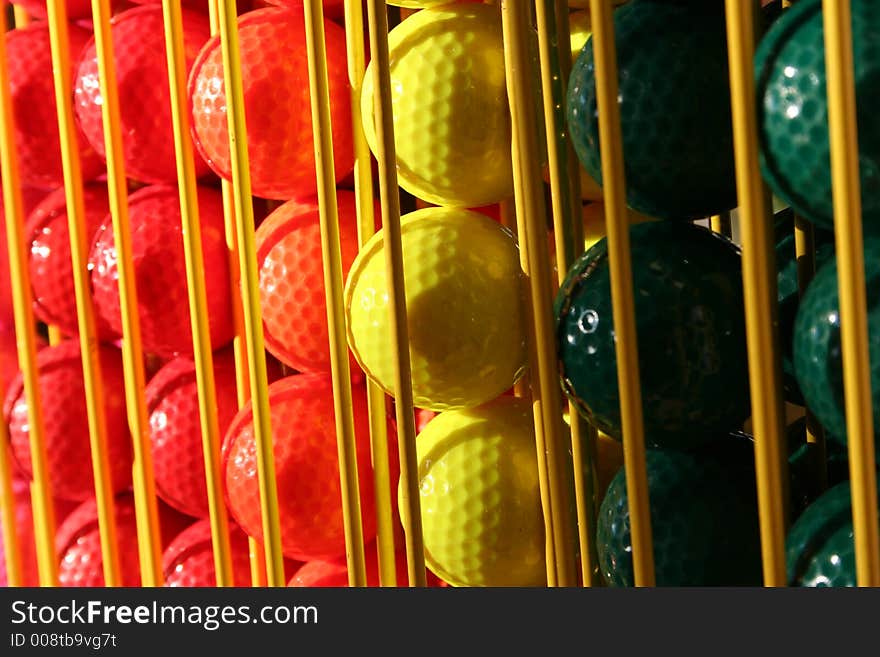 Miniature golf balls in a rack