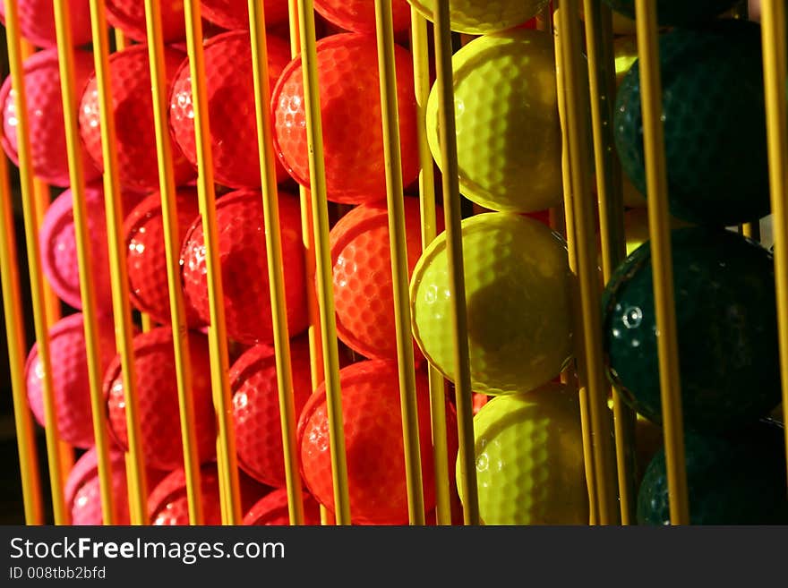 Miniature golf balls in a rack