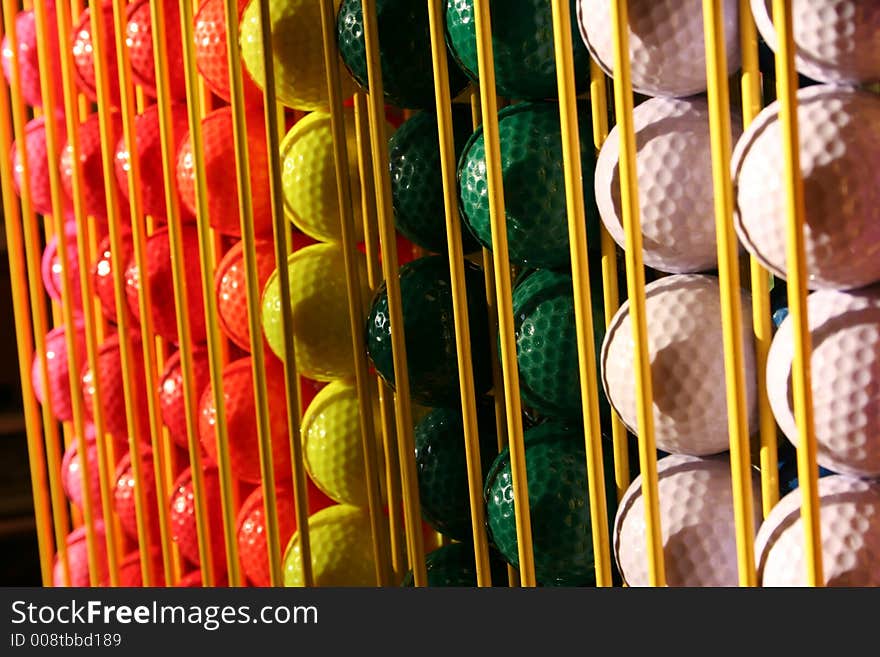 Miniature golf balls in a rack