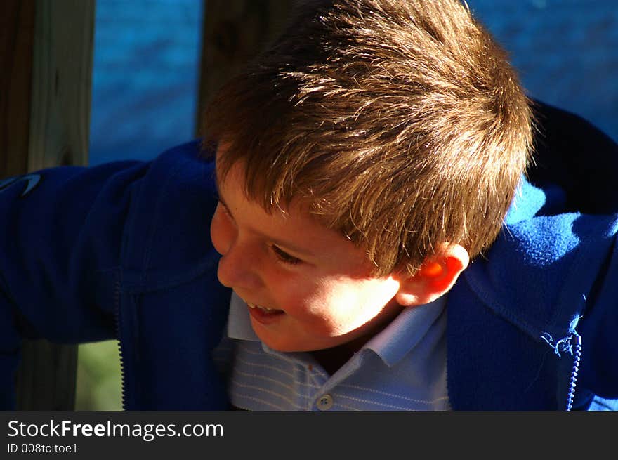 Portrait of a young boy laughing and playing on a. Portrait of a young boy laughing and playing on a