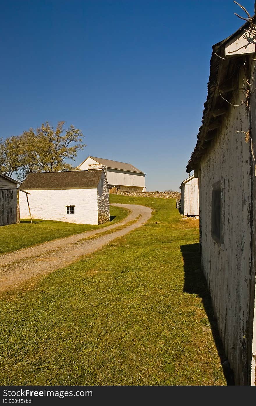 Old, antique farm buildings on the historic civil war Antietam Nationial Battlefield, Sharpsburg, Maryland. This is part of the Mumma's Farm that has been restored because it was demolished in the battle. Vertical perspective. Old, antique farm buildings on the historic civil war Antietam Nationial Battlefield, Sharpsburg, Maryland. This is part of the Mumma's Farm that has been restored because it was demolished in the battle. Vertical perspective.