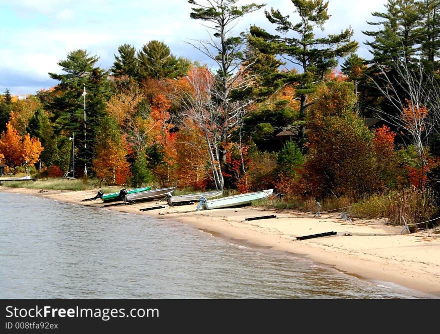 Boats on lake shore during Autumn time