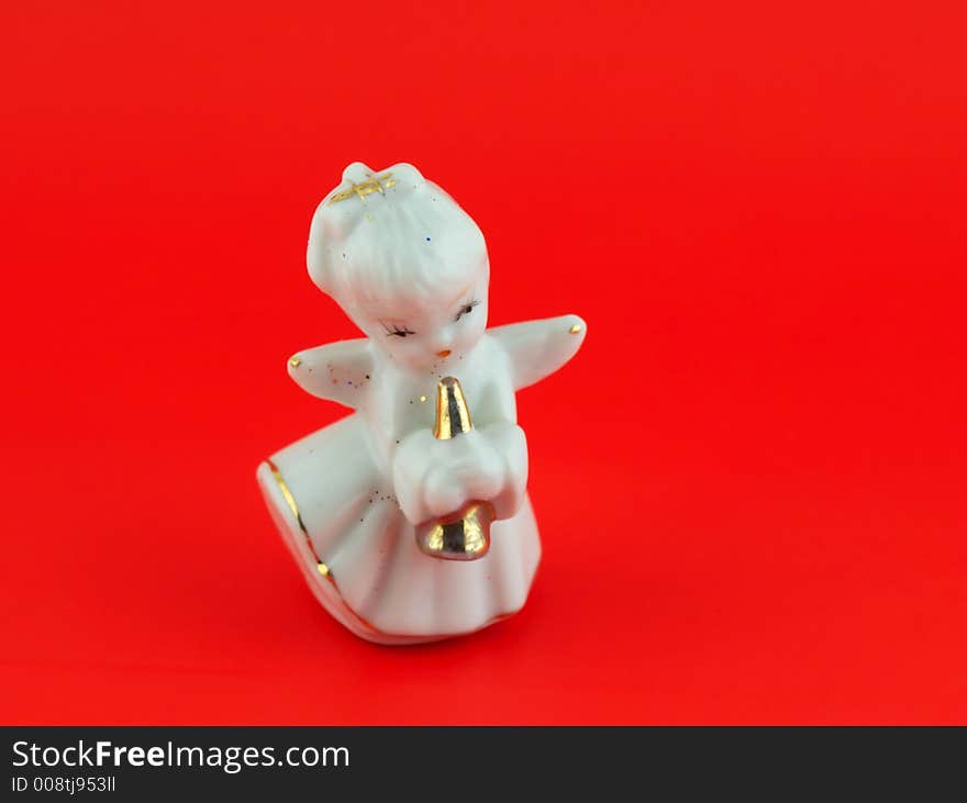 Isolated christmas decoration on red background (Angel)