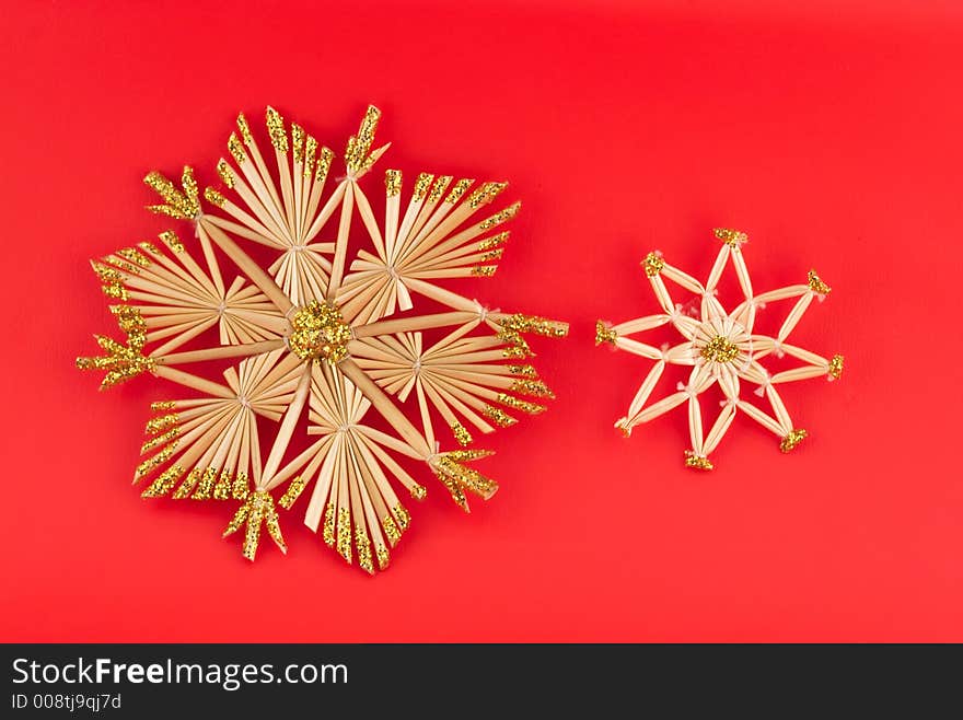 Isolated christmas decorations on red background (snow flakes, octagons)