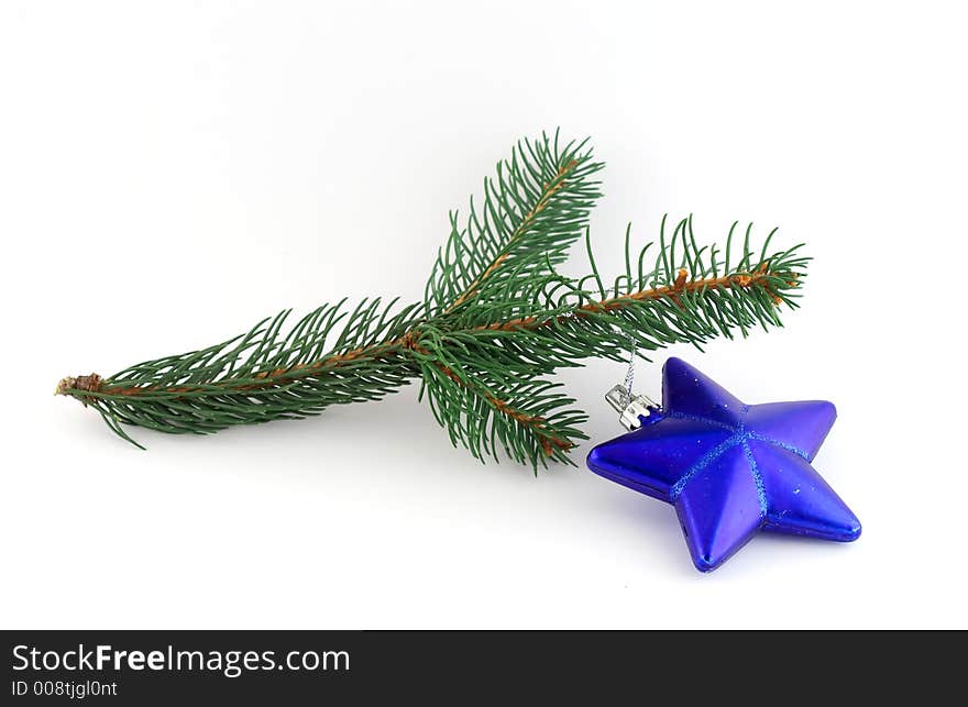 Isolated christmas decoration on white background (twig and blue star)