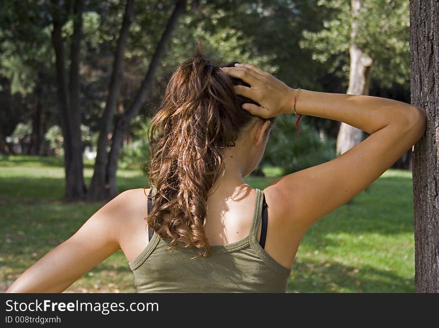 A teen thinking about something, in a nature context, express, feelings og loneliness or trouble. A teen thinking about something, in a nature context, express, feelings og loneliness or trouble