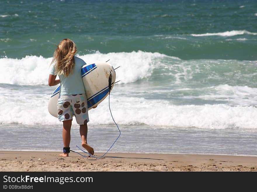 Young girl try to surf the ocean waves. Young girl try to surf the ocean waves