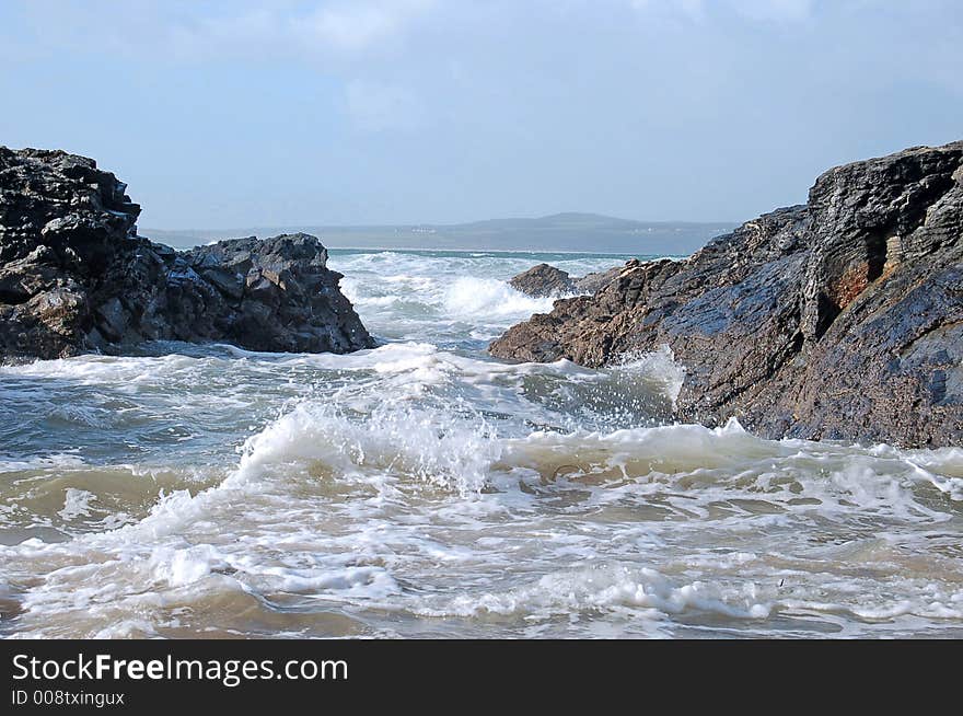 Seascape showing waves advancing through rocks just offshore in cornwall england on an autumn morning. Seascape showing waves advancing through rocks just offshore in cornwall england on an autumn morning