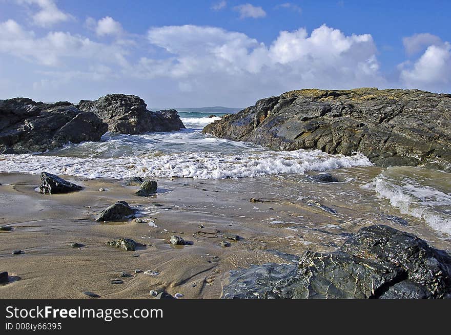 Seascape showing waves advancing through rocks just offshore in cornwall england on an autumn morning. Seascape showing waves advancing through rocks just offshore in cornwall england on an autumn morning