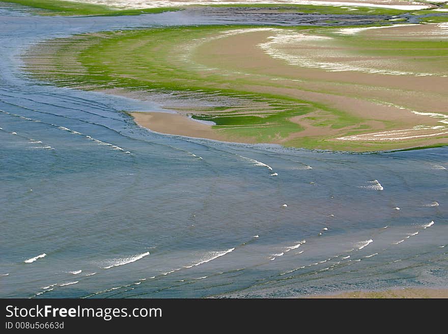 With seaweed covered sand on the beach of Saint Michel-en-Grève (Bretagne)