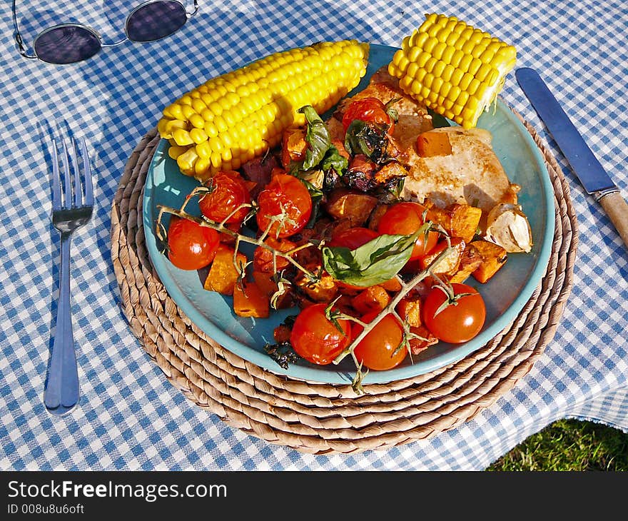 A healthy meal, consisting of corn, tomatoes, potatoes and some meat.