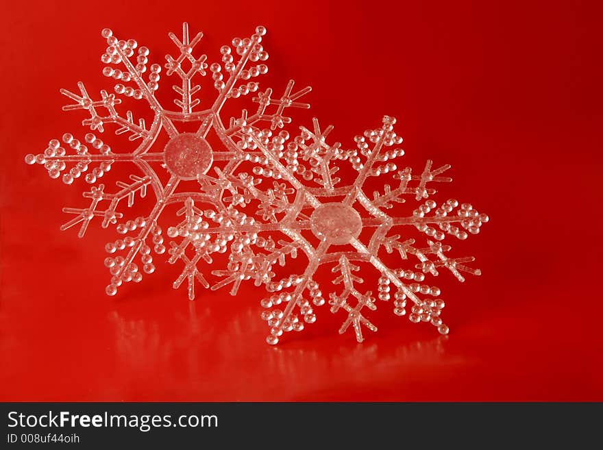 Glittery snowflake ornaments on a red background. Glittery snowflake ornaments on a red background