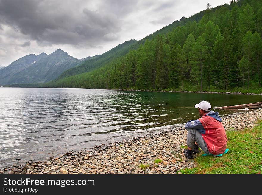 Men, lake and mountains