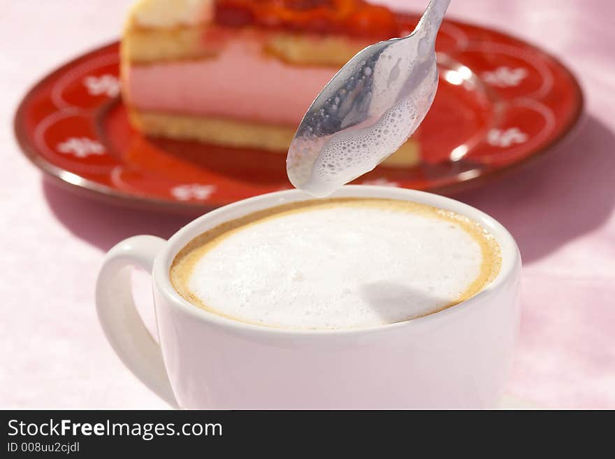 A cup of coffee and one  piece of strawberry cake. A cup of coffee and one  piece of strawberry cake