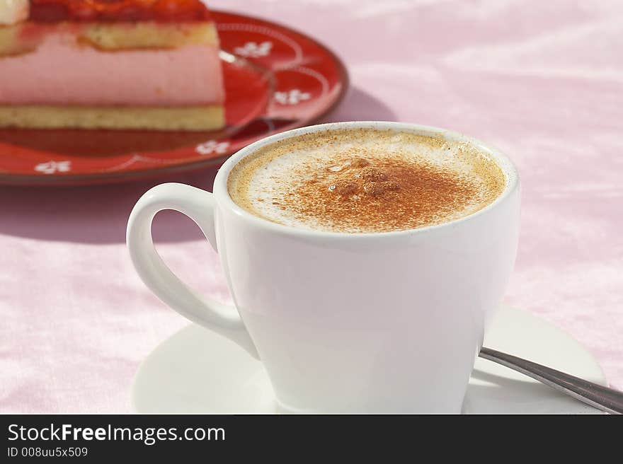 A cup of coffee and one  piece of strawberry cake. A cup of coffee and one  piece of strawberry cake