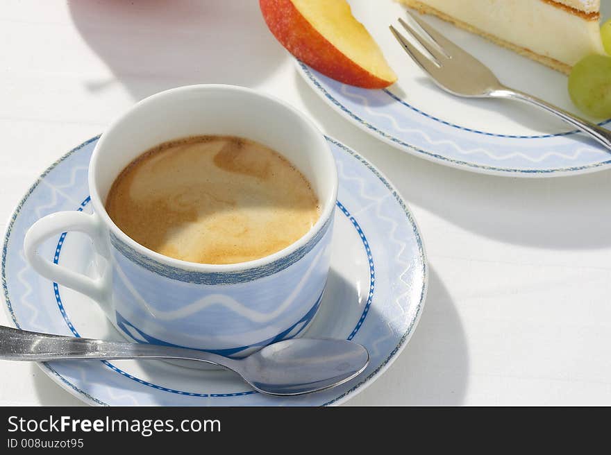 A piece of cheese cake, an apple,a  pear  and a cup of coffe on white background. A piece of cheese cake, an apple,a  pear  and a cup of coffe on white background