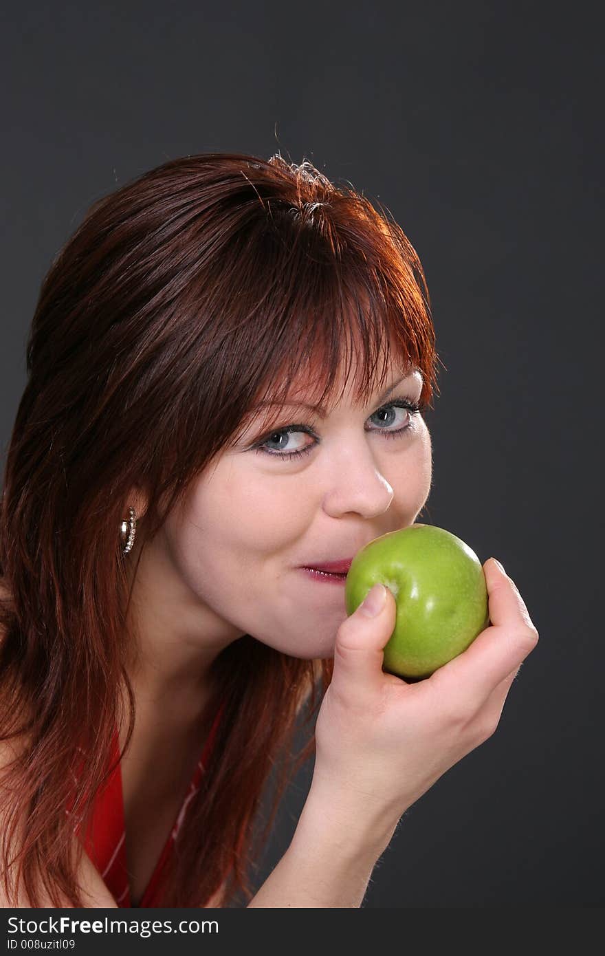 Beautiful girl loves to eat a green fresh apple. Beautiful girl loves to eat a green fresh apple