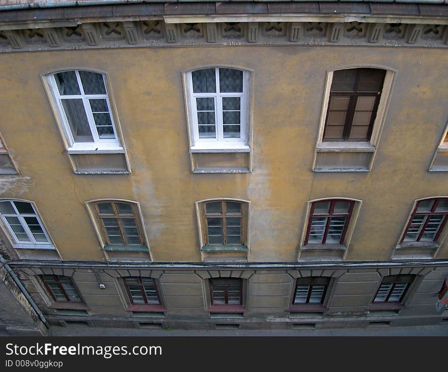 Old rundown buildings in eastern European city, with windows in a descending image