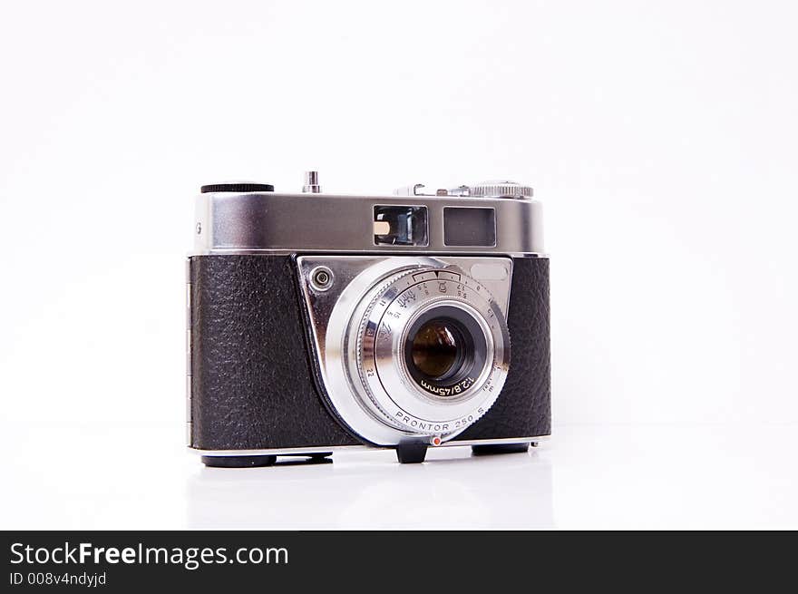 An old 35mm film camera isolated on white. An old 35mm film camera isolated on white