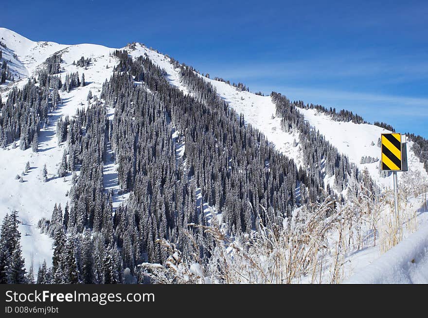 Winter Mountain And Road Sign