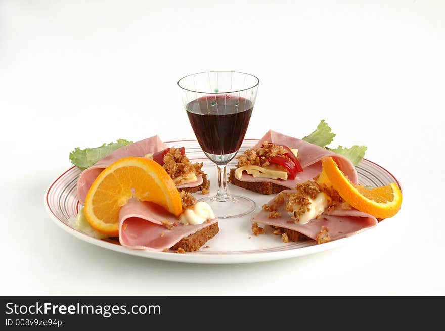 A dish of salami and wine. A dish of salami and wine