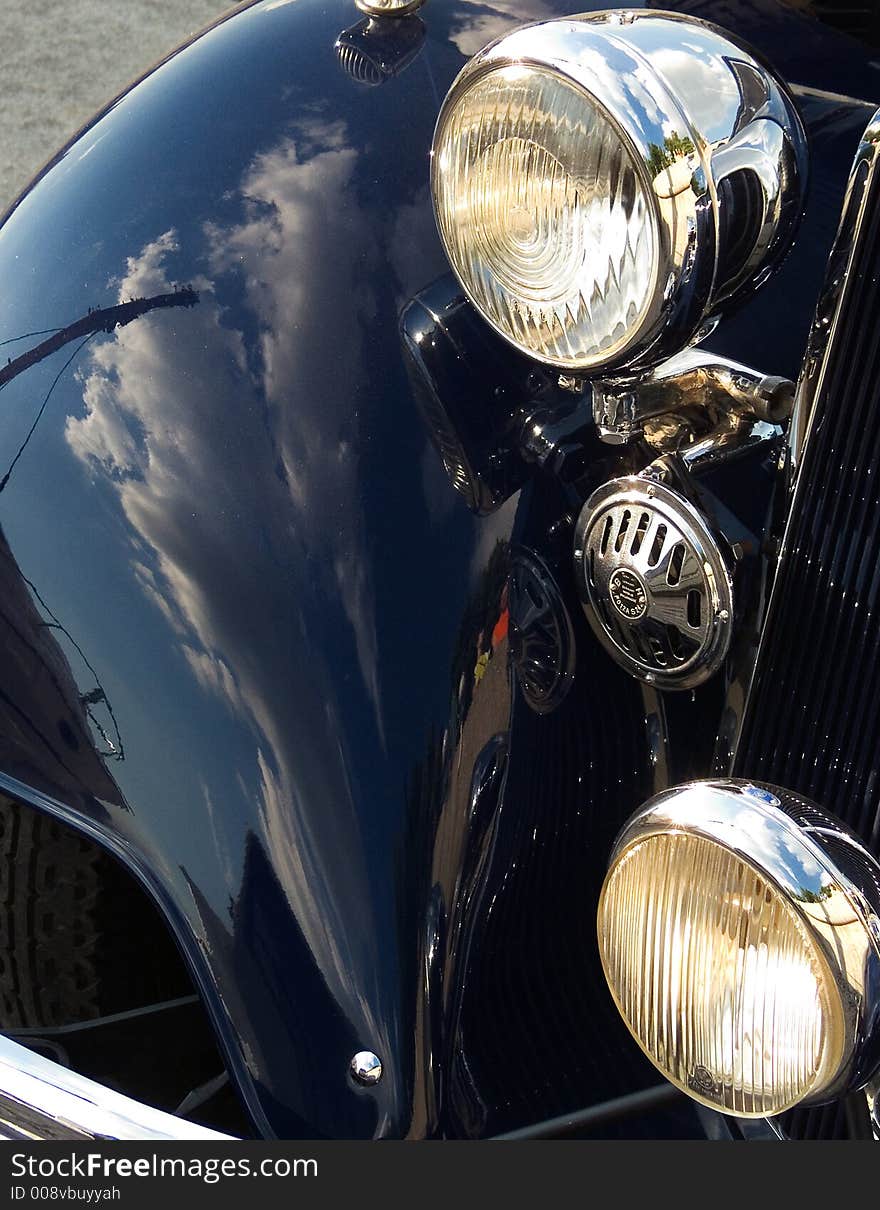 Classic car closeup - side panel, signal and headlamp