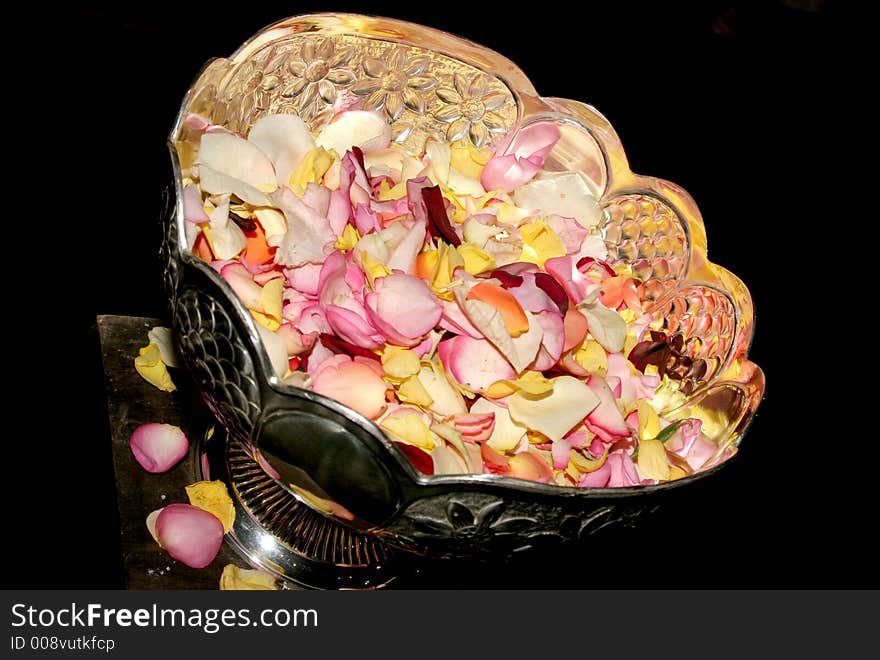 A stainless bowl filled with rose petals for confetti. A stainless bowl filled with rose petals for confetti