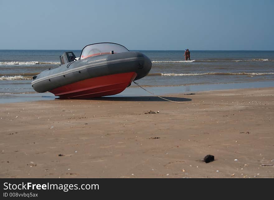 A speedboat on the beach with the sea on the horizon. A speedboat on the beach with the sea on the horizon