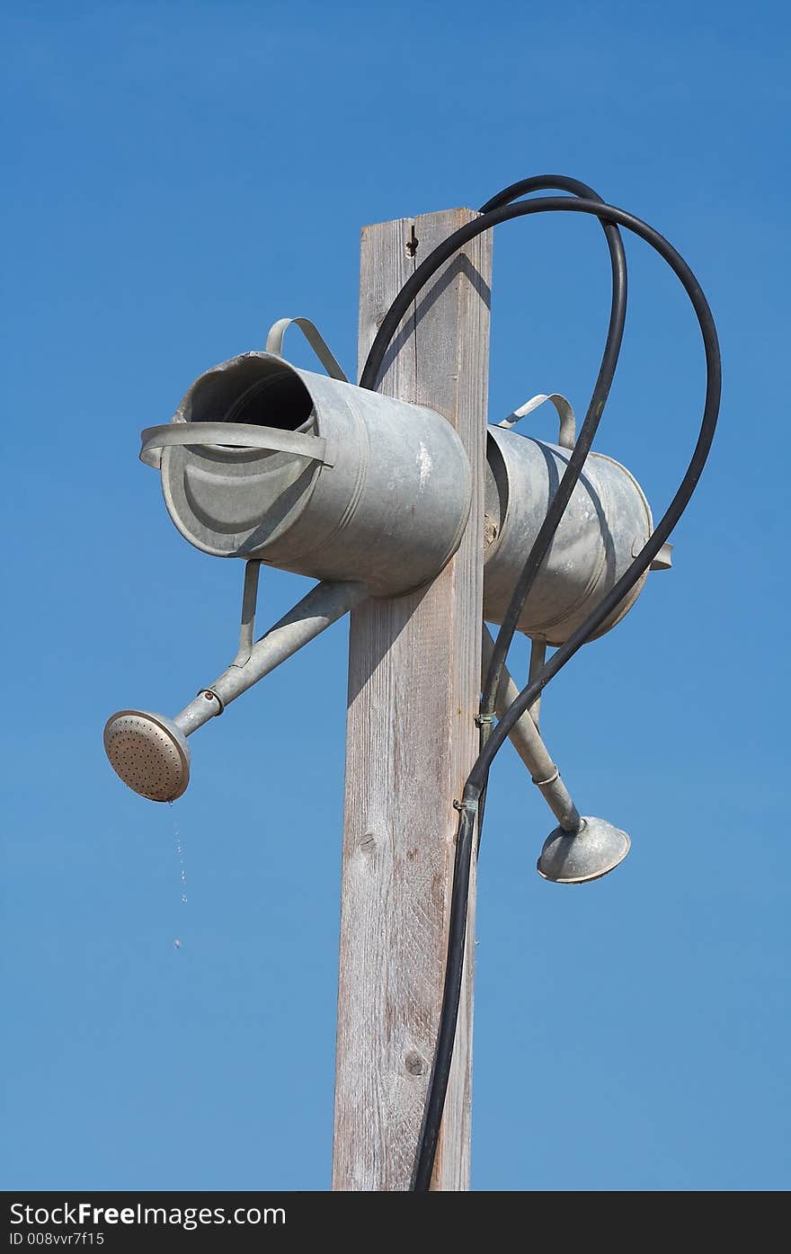 Keep it simple, a humorous (fully functional) beach shower. Two water cans connected by water pipe.