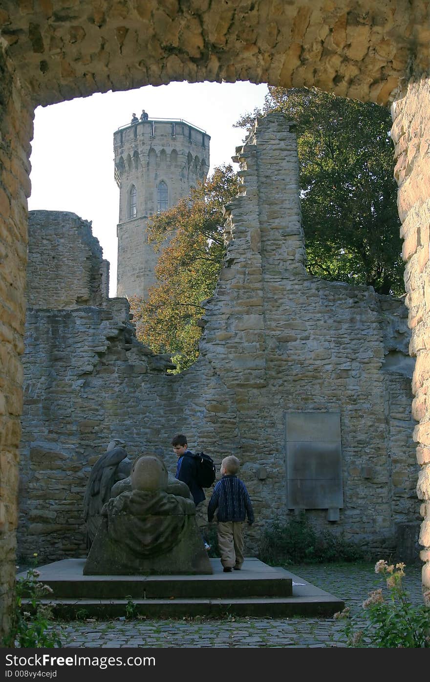 Two boys have seen a gravestone in ruins of an old fortress. Two boys have seen a gravestone in ruins of an old fortress