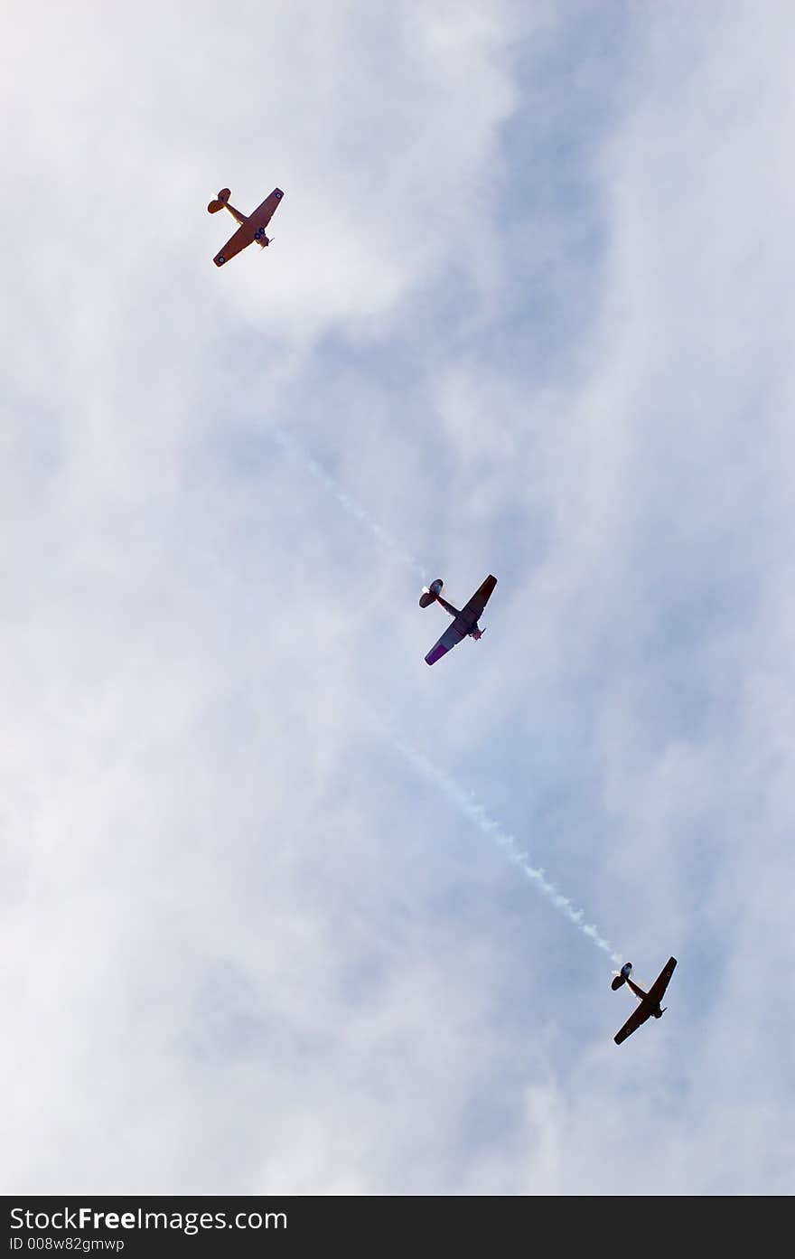 Harvard T-6's fly past during an air show. As seen from below. Harvard T-6's fly past during an air show. As seen from below.