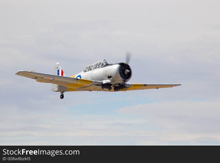 A T-6 Harvard zooms past at an air show. A T-6 Harvard zooms past at an air show.