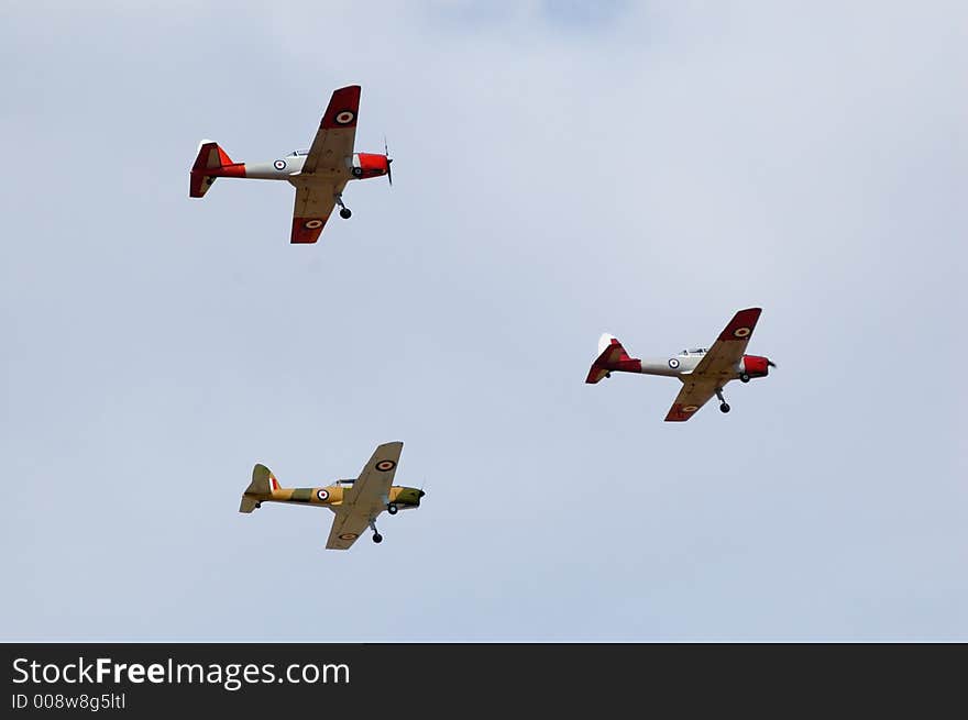 De Havilland DHC1 Chipmunks flies past during an air show. De Havilland DHC1 Chipmunks flies past during an air show.