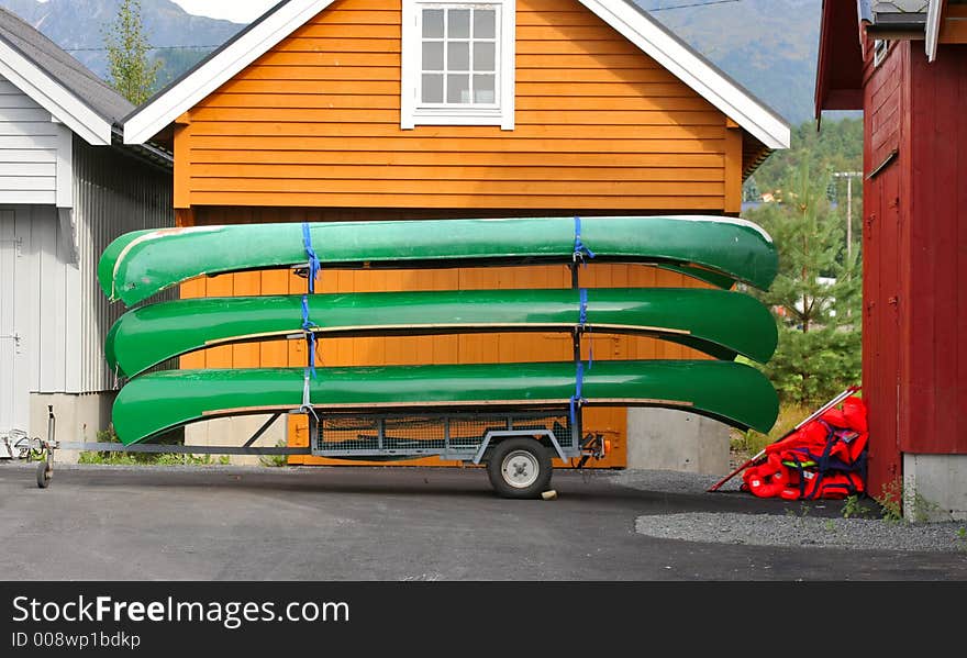 Green canoes stacked on a hanger