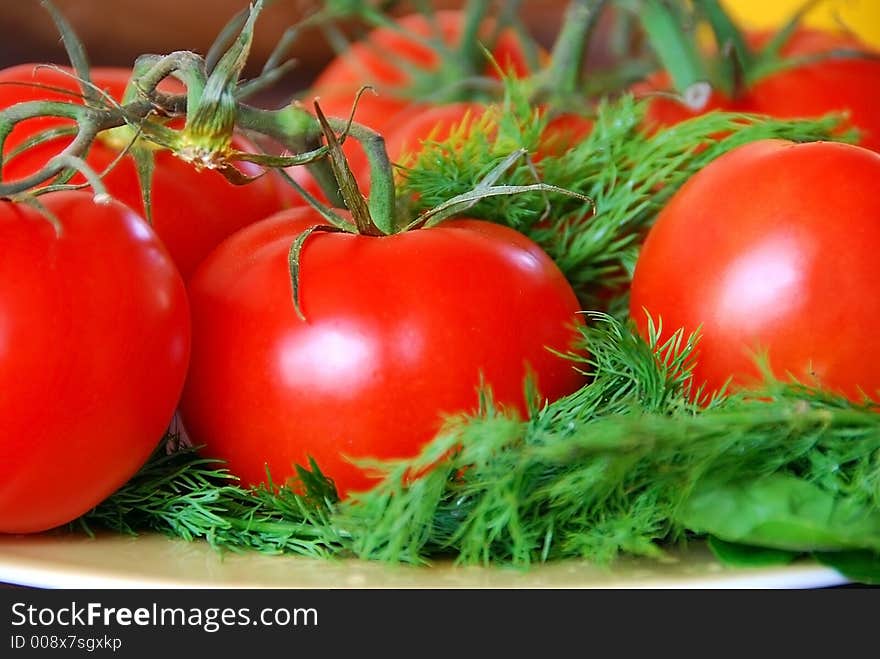 A bunch of lovely red fresh tomatoes in focus. A bunch of lovely red fresh tomatoes in focus