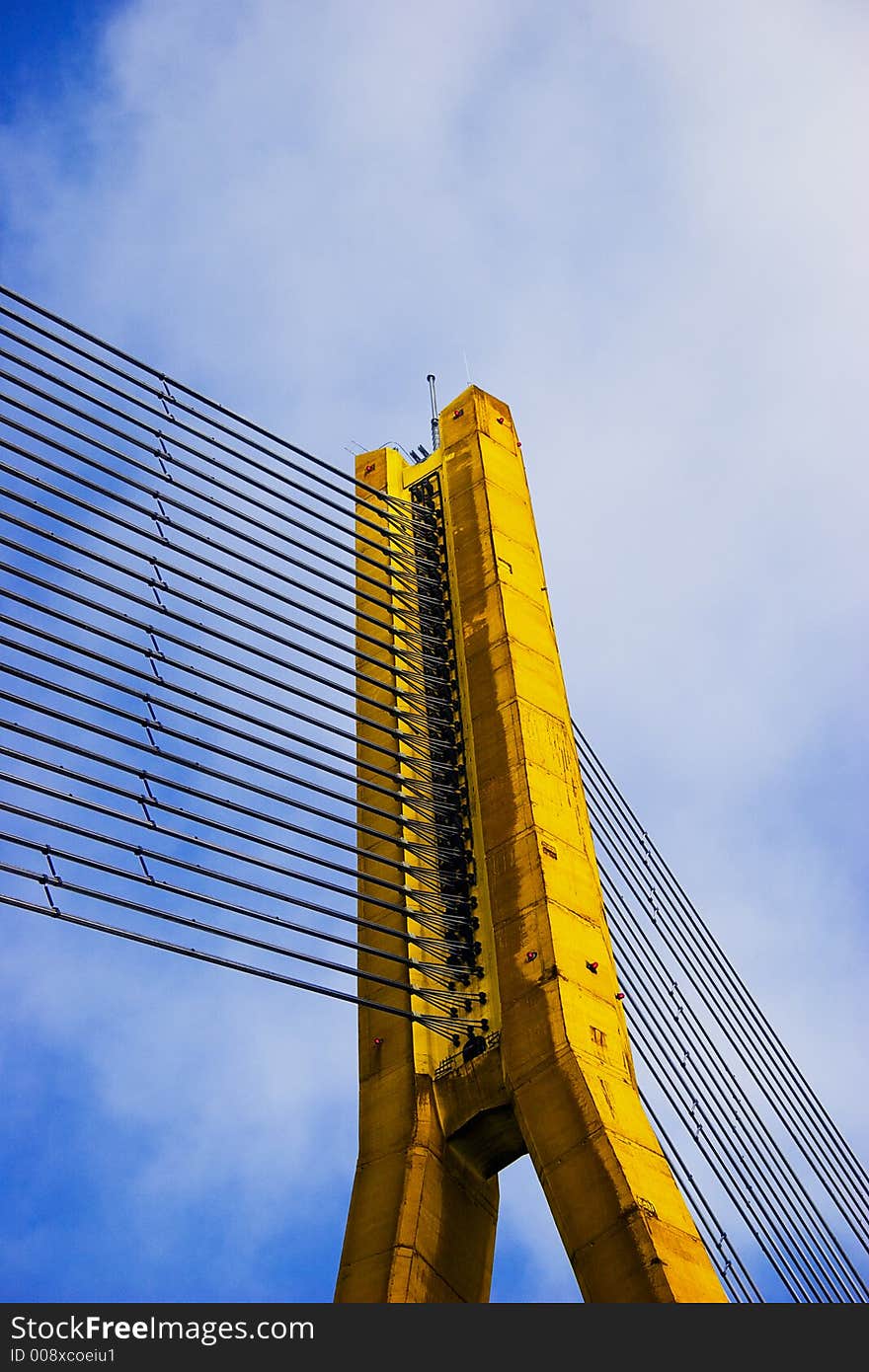 Modern Yellow Cable bridge closeup on blue sky