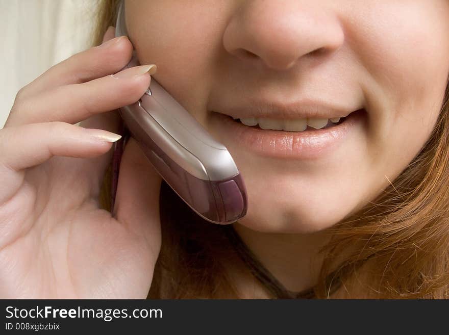 Girl speaking by the phone (close up)