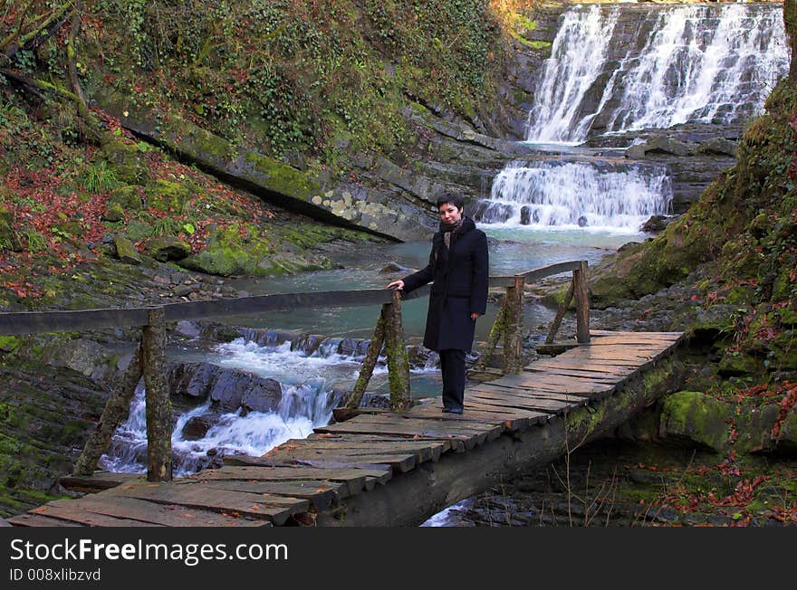 Wild waterfall with bridge