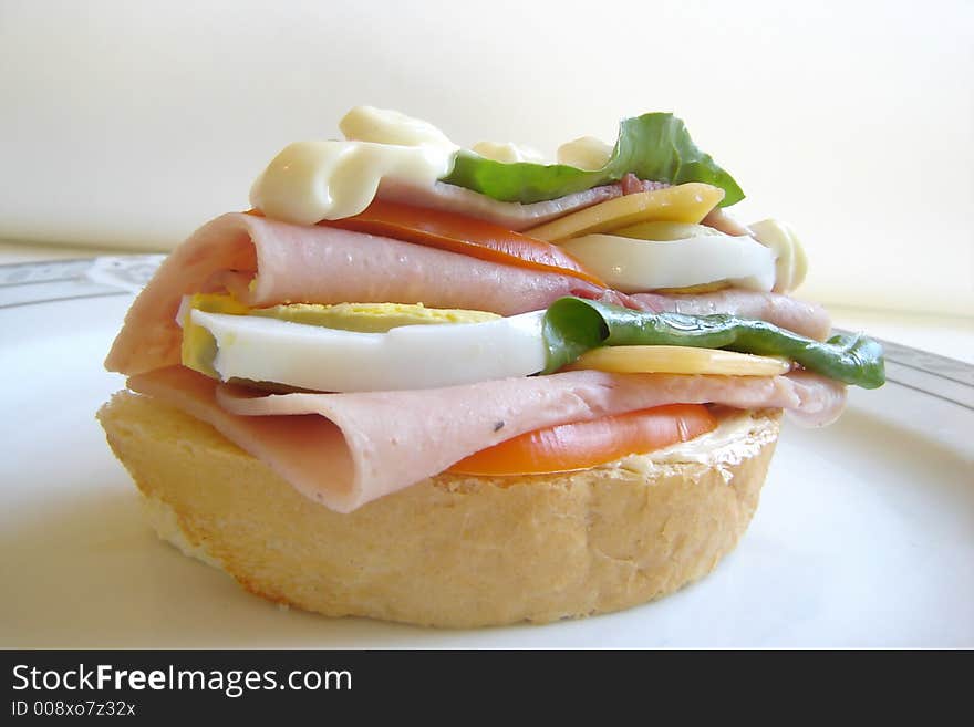 Delicious gourmet sandwich with ham, eggs, mayonnaise, salad and ketchup. Delicious gourmet sandwich with ham, eggs, mayonnaise, salad and ketchup.