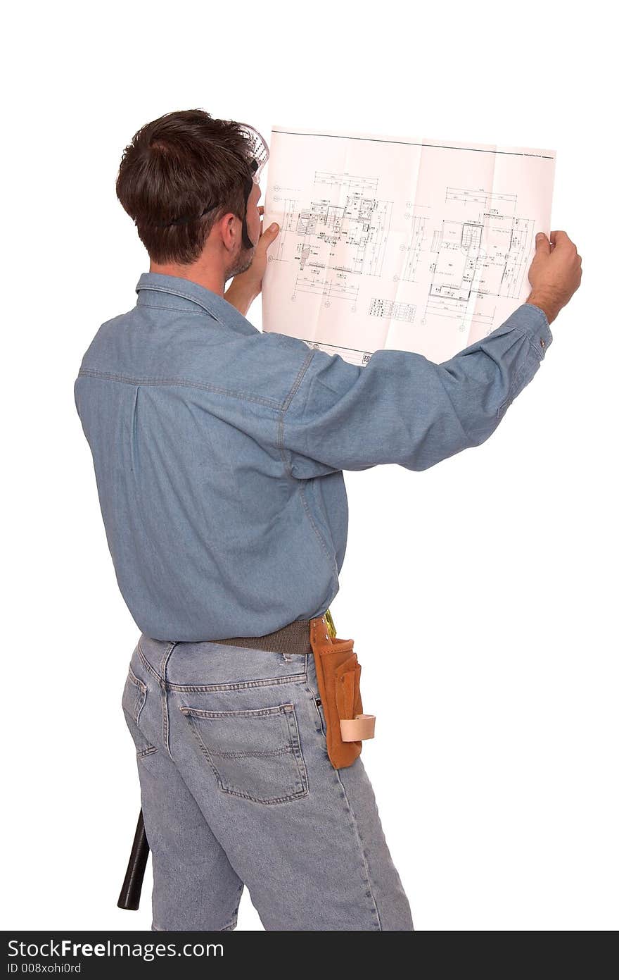 Carpenter reading blueprints with back to the camera. Carpenter reading blueprints with back to the camera