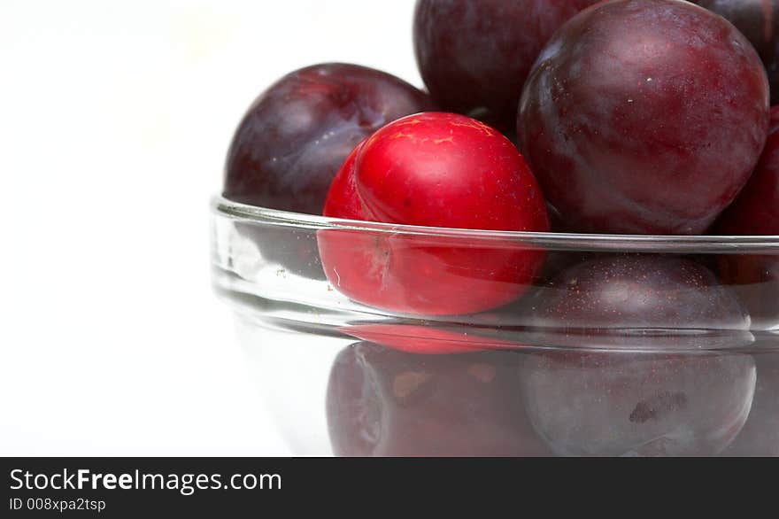 Bowl of Plums against a white background