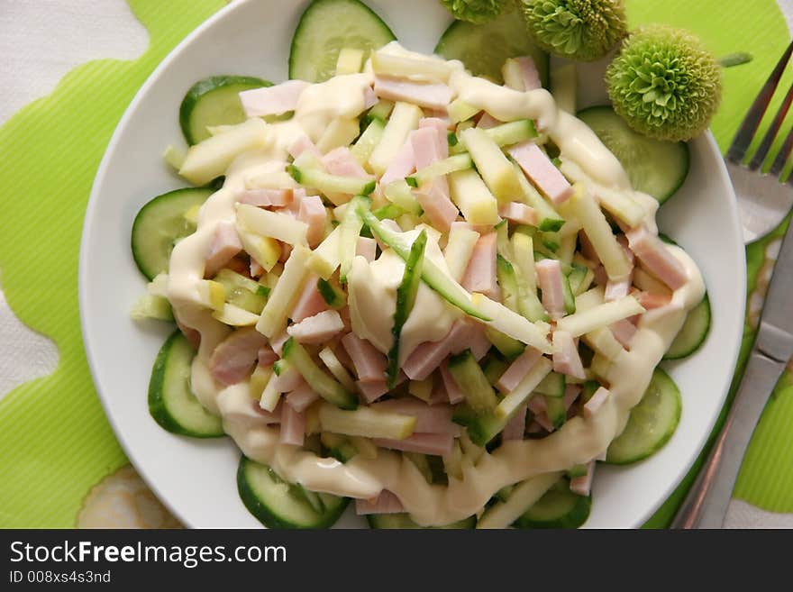 Salad made of ham, apples and fresh cucumbers. Salad made of ham, apples and fresh cucumbers.