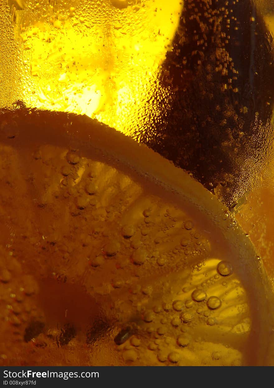 Lemon in the cold light beer with fork. Lemon in the cold light beer with fork.