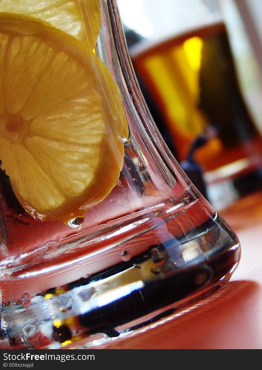 Empty glass from beer with 2 lemon pieces. Empty glass from beer with 2 lemon pieces.