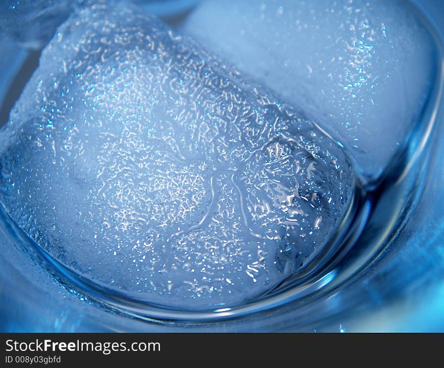 Melting ice cubes at the bottom of an empty  martini glass. Melting ice cubes at the bottom of an empty  martini glass