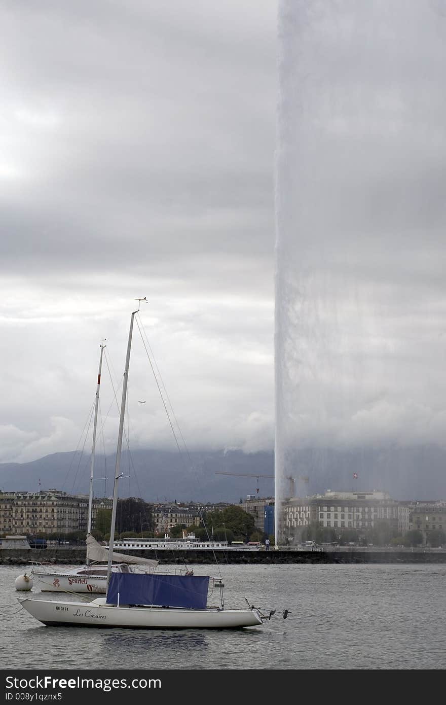 Powerful fountain on Lake Geneva on a very cloudy day. Powerful fountain on Lake Geneva on a very cloudy day